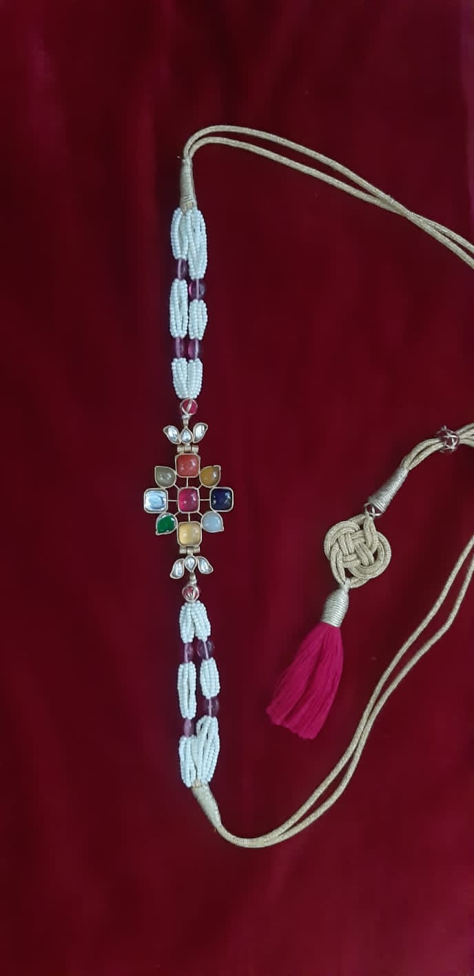 Sterling Silver Navratana Jadau choker with semi precious stones, faux pearls.
Adjustable thread sarafa closure.