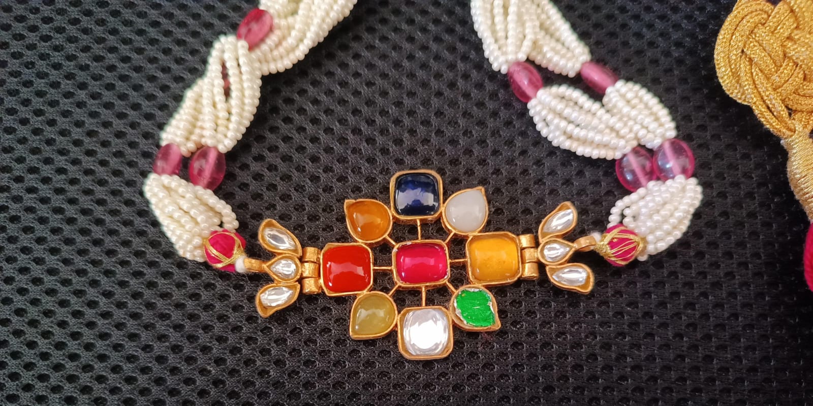 Sterling Silver Navratana Jadau choker with semi precious stones, faux pearls.
Adjustable thread sarafa closure.