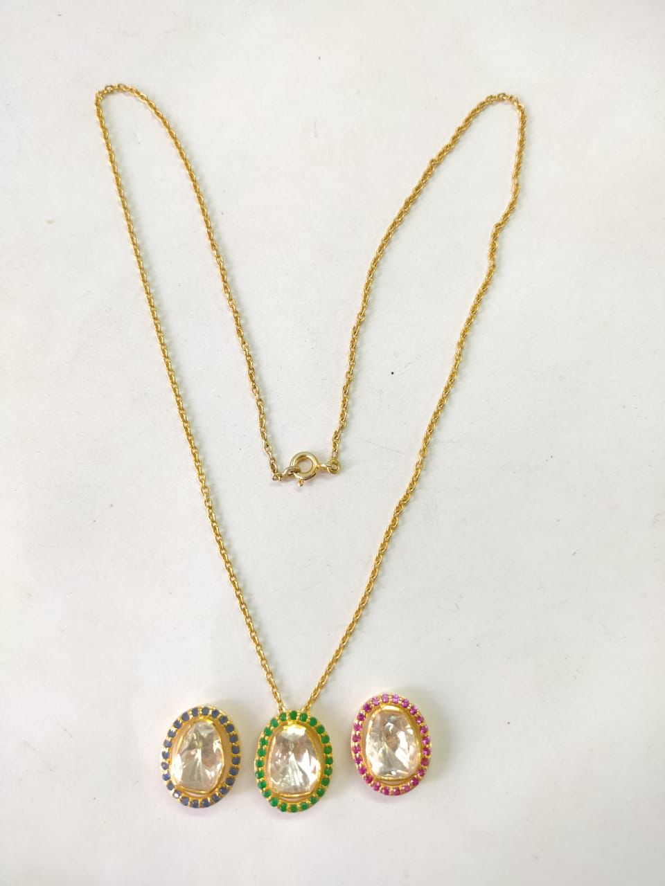 Three-in-one oval Pendant Necklace:
Ruby red, Emerald green and blue Sapphire stones with Moissanite diamond set in sterling silver
1 micron gold plating