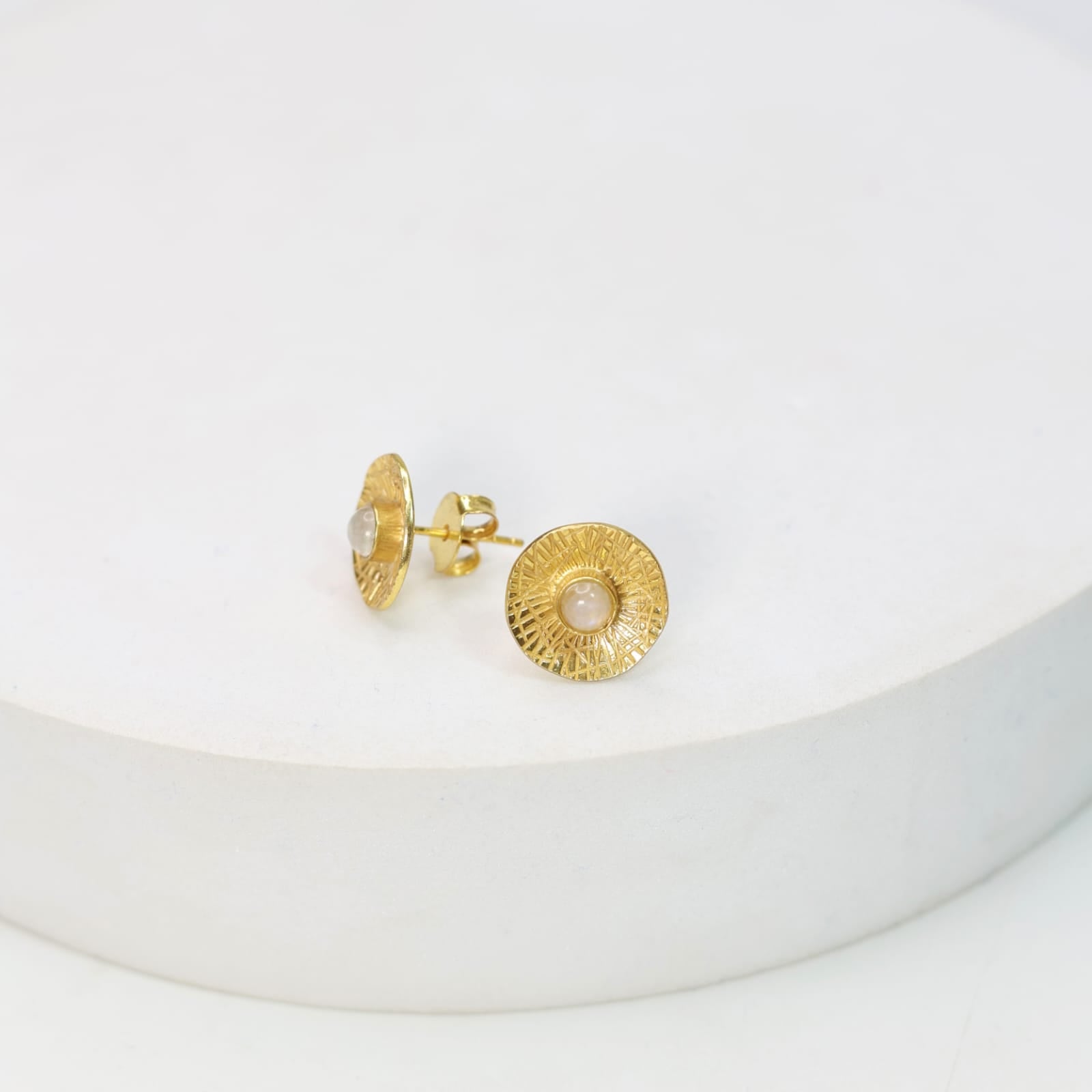 Sterling Silver stud earrings with 18 karat micron plating patterned tops with moonstones in Push-Post closure.