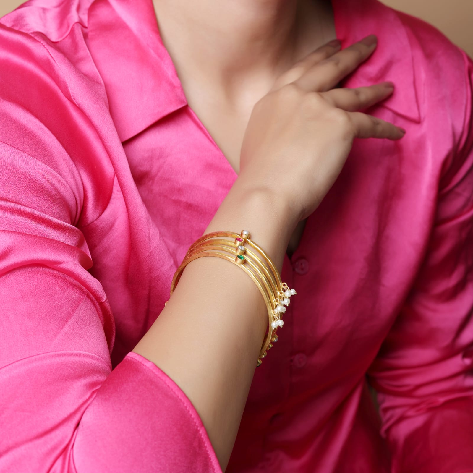 Stacking Bracelet/Bangle in
92.5 sterling Silver, 18 karat Gold plating with Pearls, Polki, red Quartz and green Onyx.
(Set of 4).