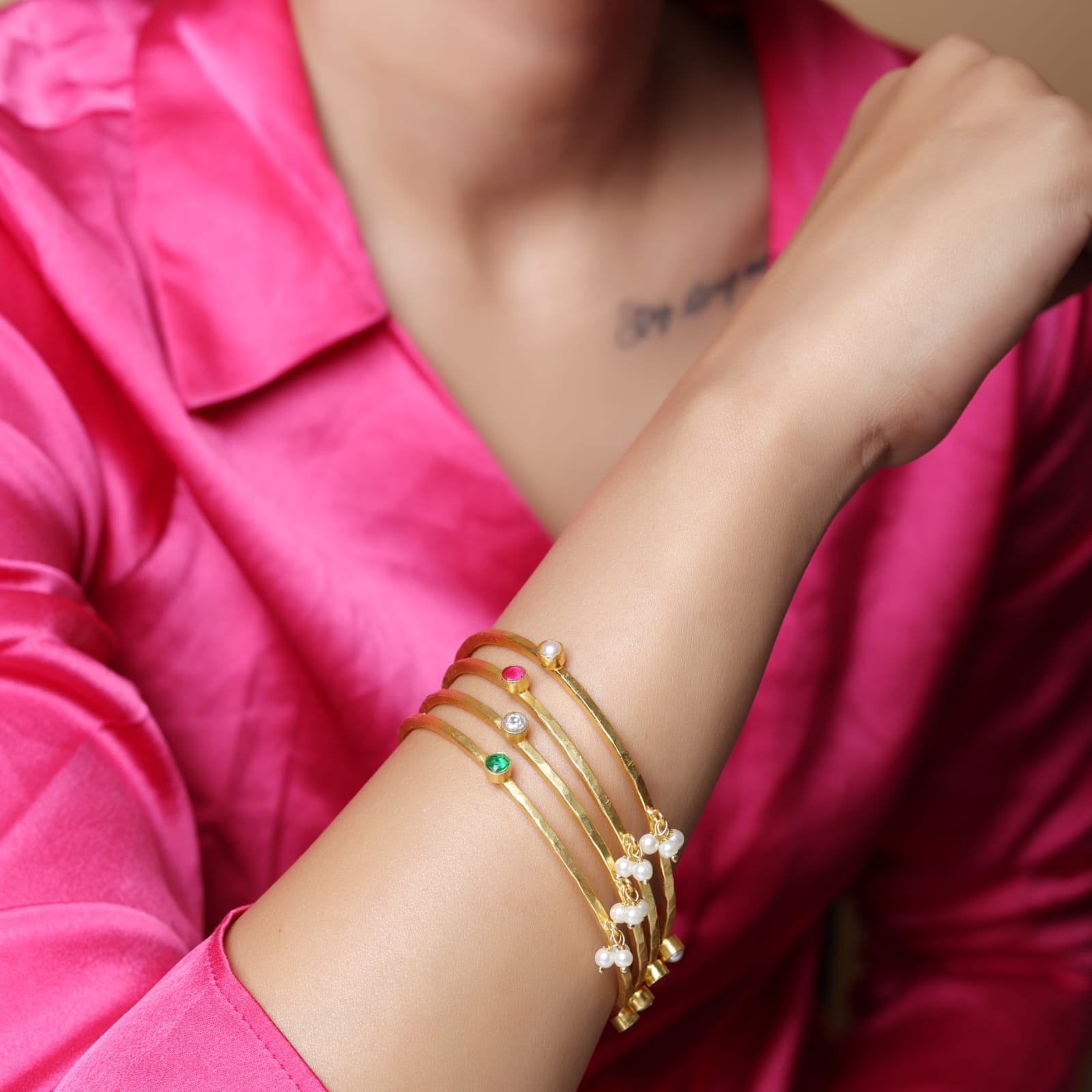 Stacking Bracelet/Bangle in
92.5 sterling Silver, 18 karat Gold plating with Pearls, Polki, red Quartz and green Onyx.
(Set of 4).