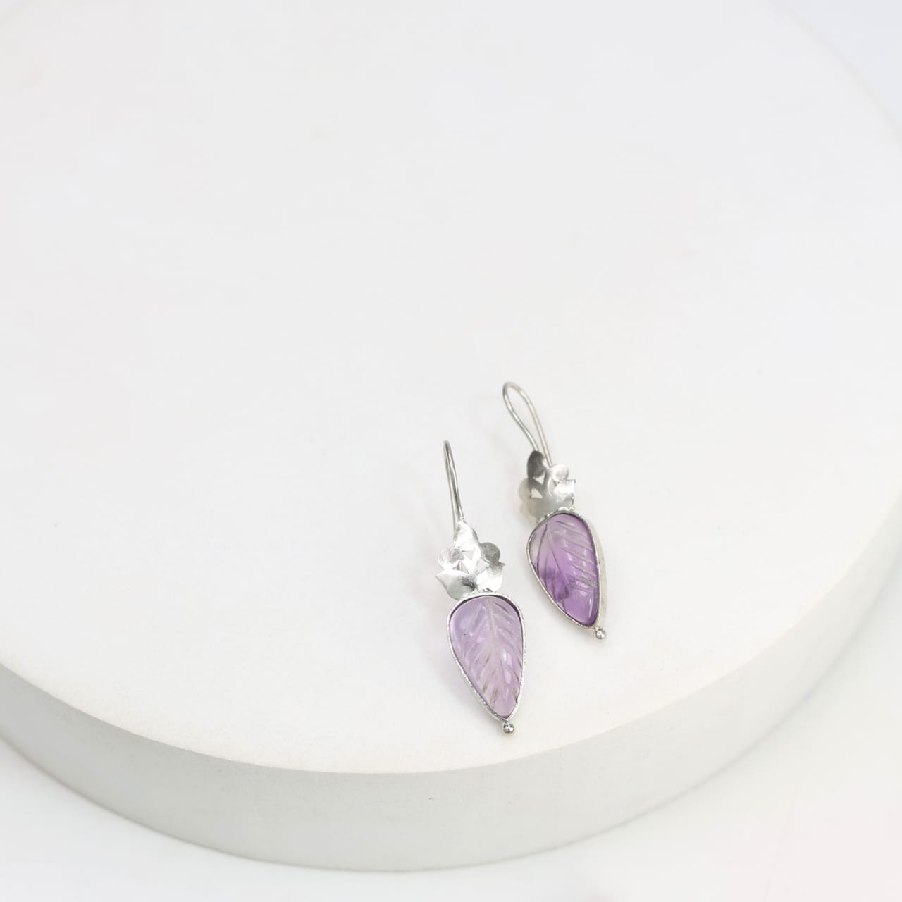 Carved amethyst hook earrings set in sterling Silver.