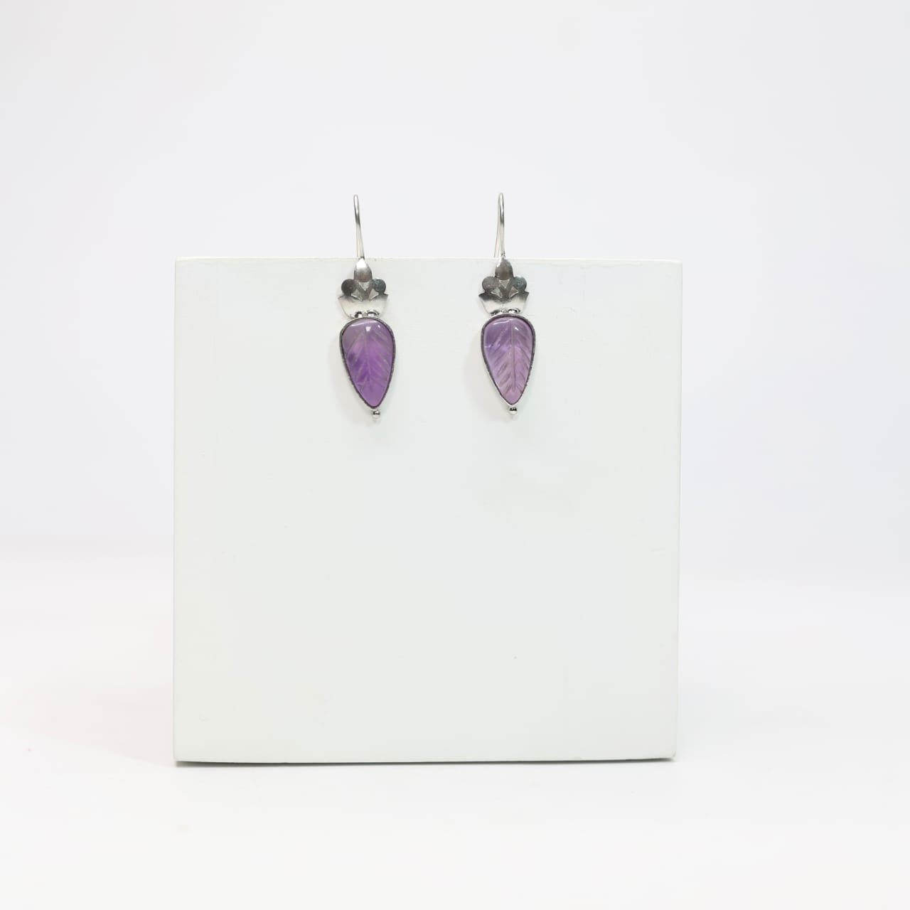 Carved amethyst hook earrings set in sterling Silver.
