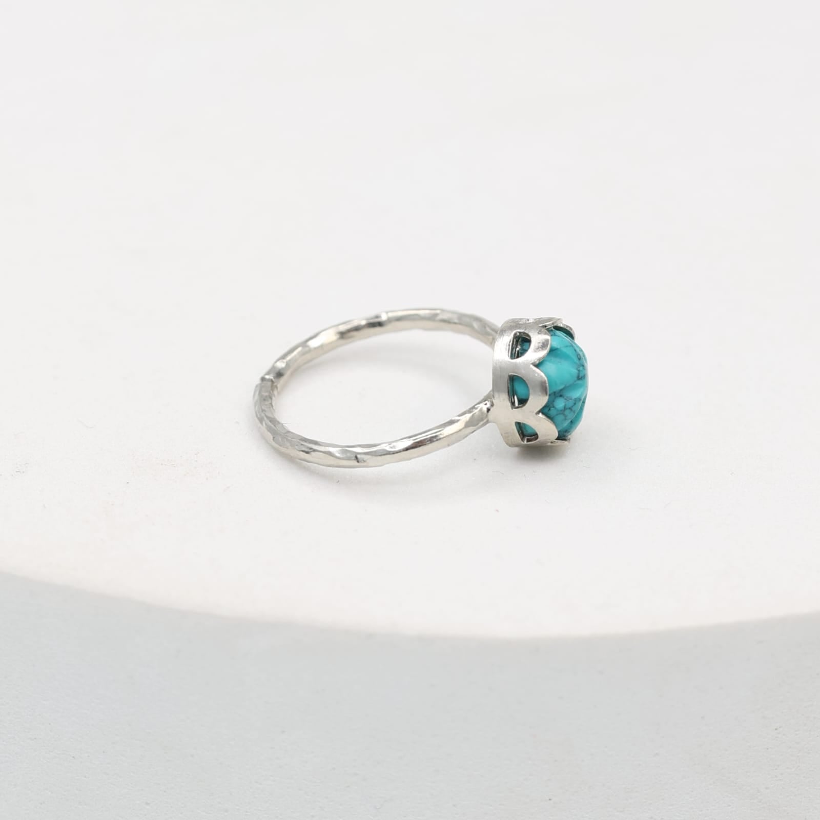 Carved turquoise ring set in sterling Silver, hammered ring band.