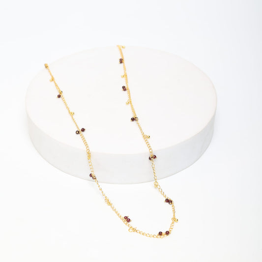 Sterling Silver chain with Garnet and ghungroos in 18 karat Gold plating.