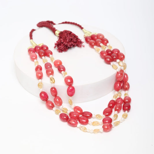 Red tumbles, yellow aventurine and Pearl three layered string necklace in a red thread sarafa closure.