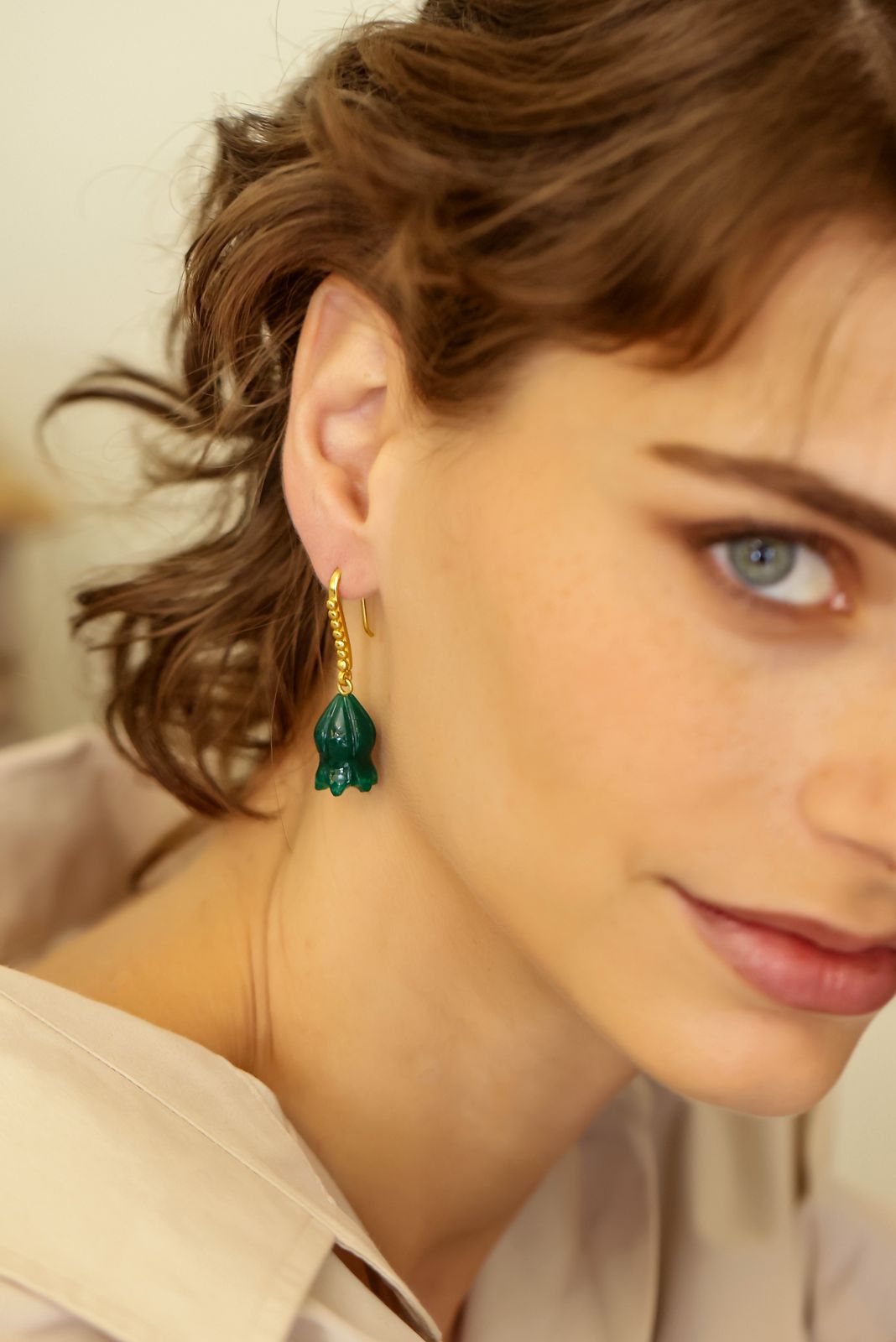 Gulband earrings in 92.5 Sterling Silver dipped in 18kt Gold plating, with
Green Onyx dome shaped Jhumki Earrings.