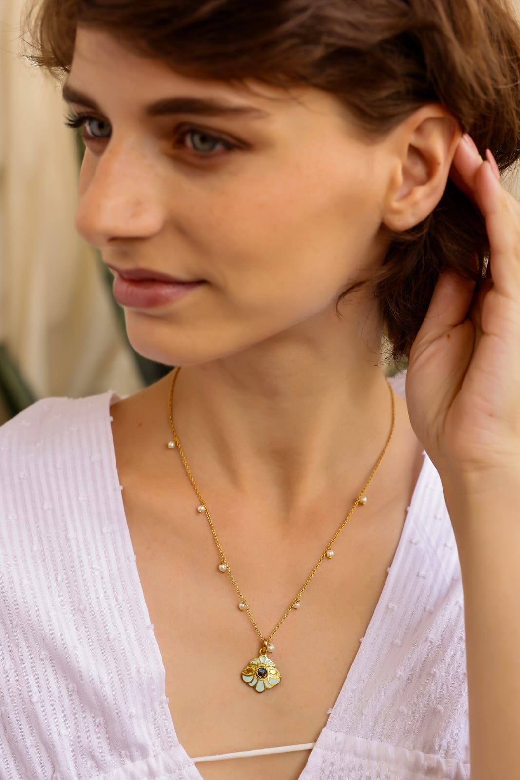 Flower enamel pendant set in 92.5 Sterling silver, strung with pearls in
S-hook closure, stacking chain.