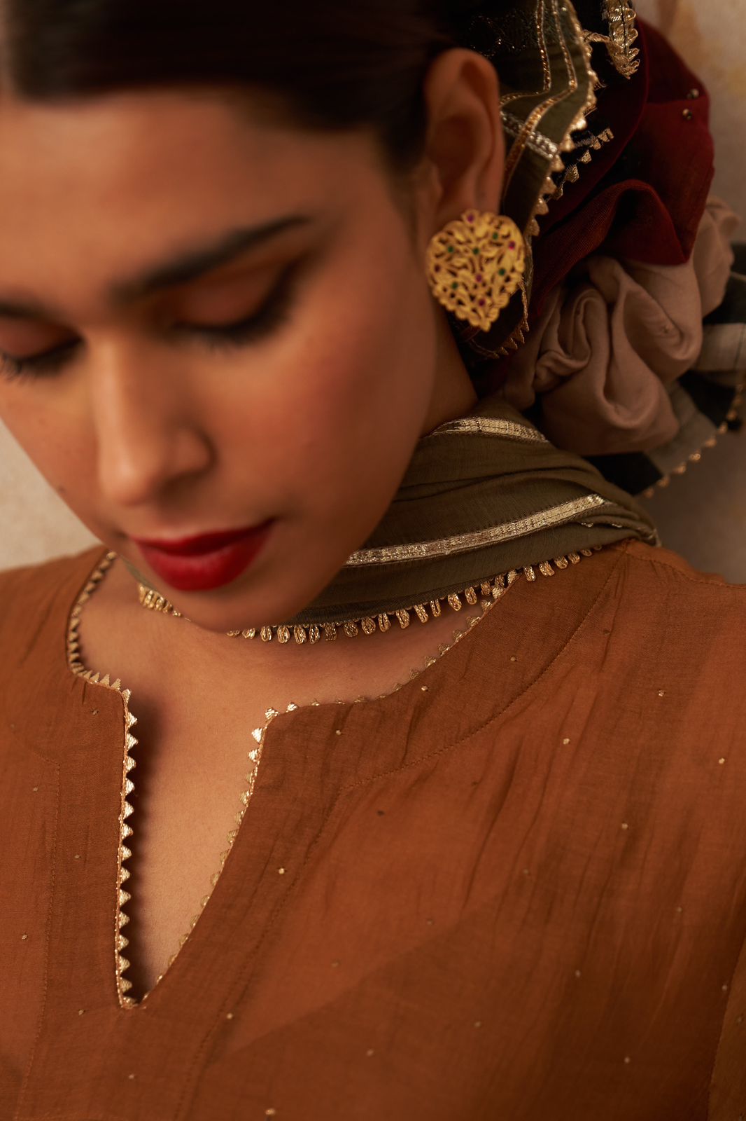 Dil earrings in 92.5 Sterling Silver with Jadau green and red stones in Post-Push closure styled in traditional motifs.