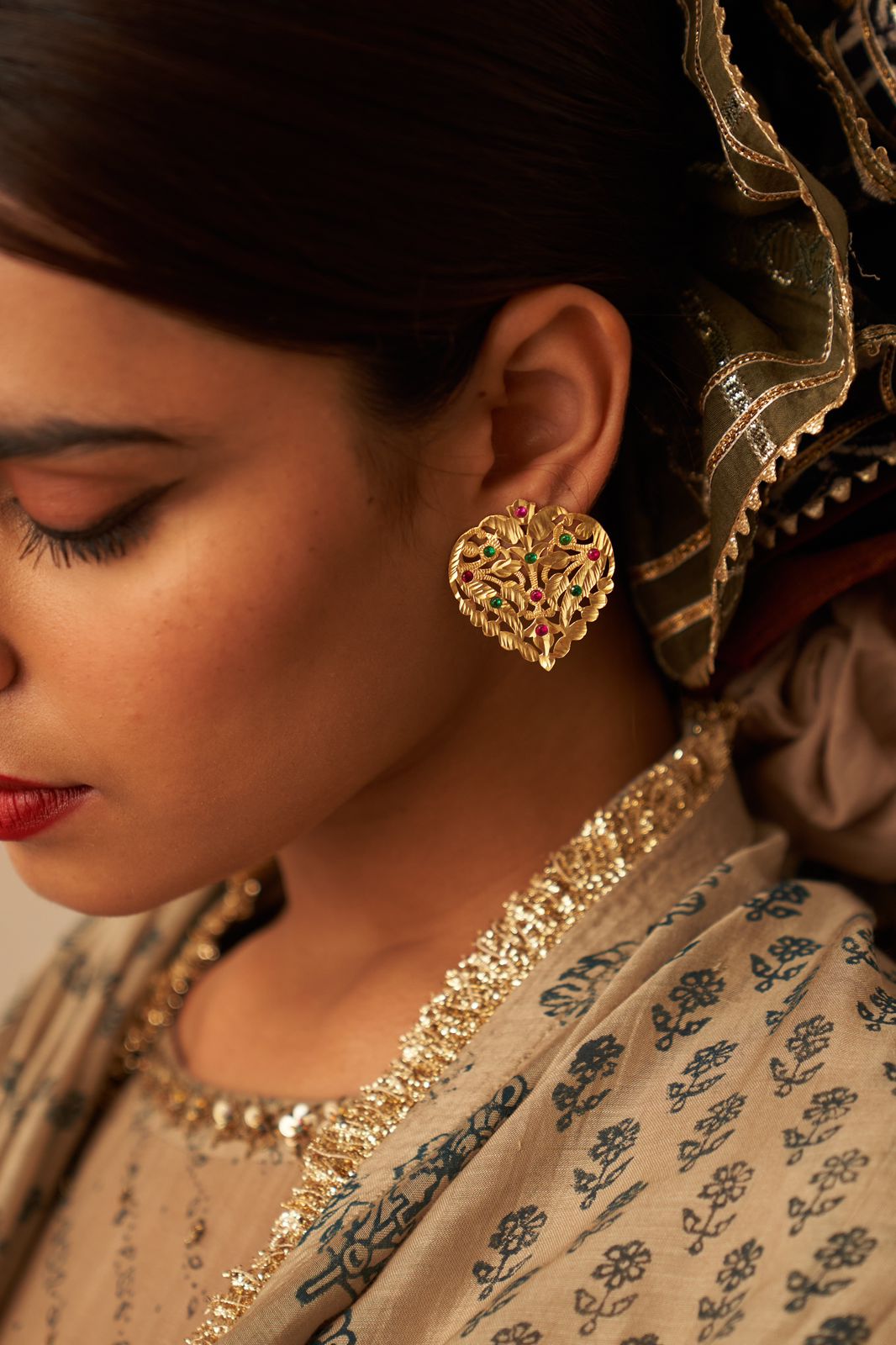 Dil earrings in 92.5 Sterling Silver with Jadau green and red stones in Post-Push closure styled in traditional motifs.