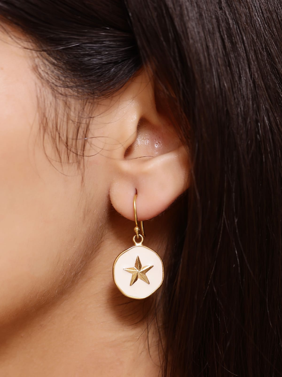 Sterling Silver star hook earrings with white enamel in 18 karat Gold plating.