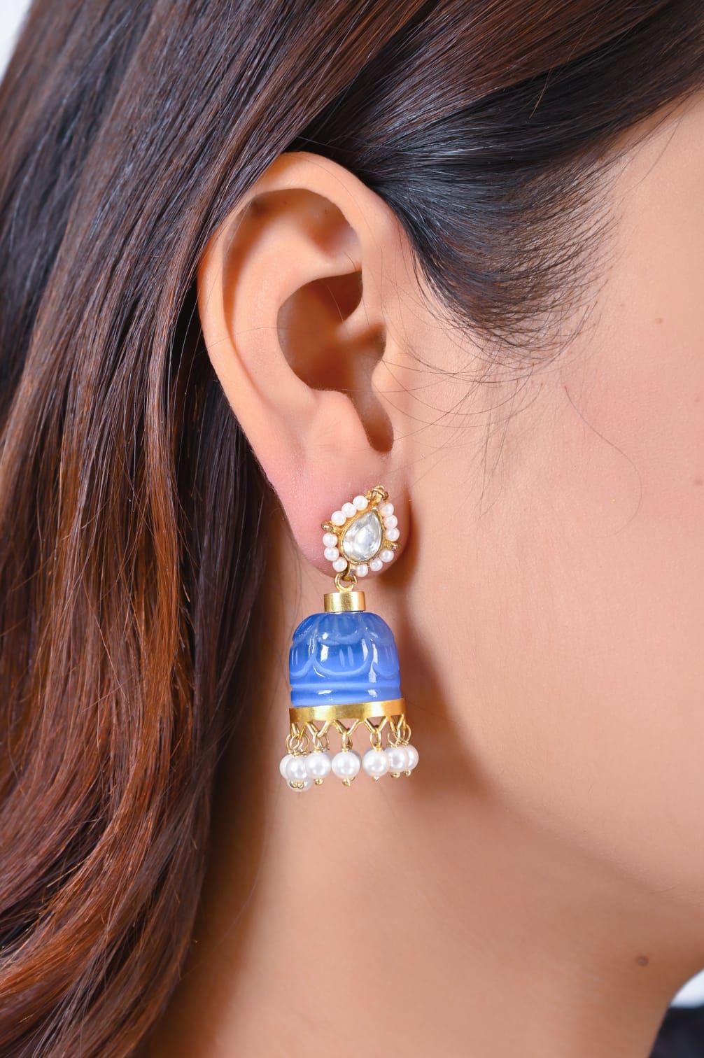 Stone jhumka in 92.5 Sterling Silver handcrafted and dipped in 1 micron Gold plating in Jadau-Polki in a traditional blue Quartz dome.