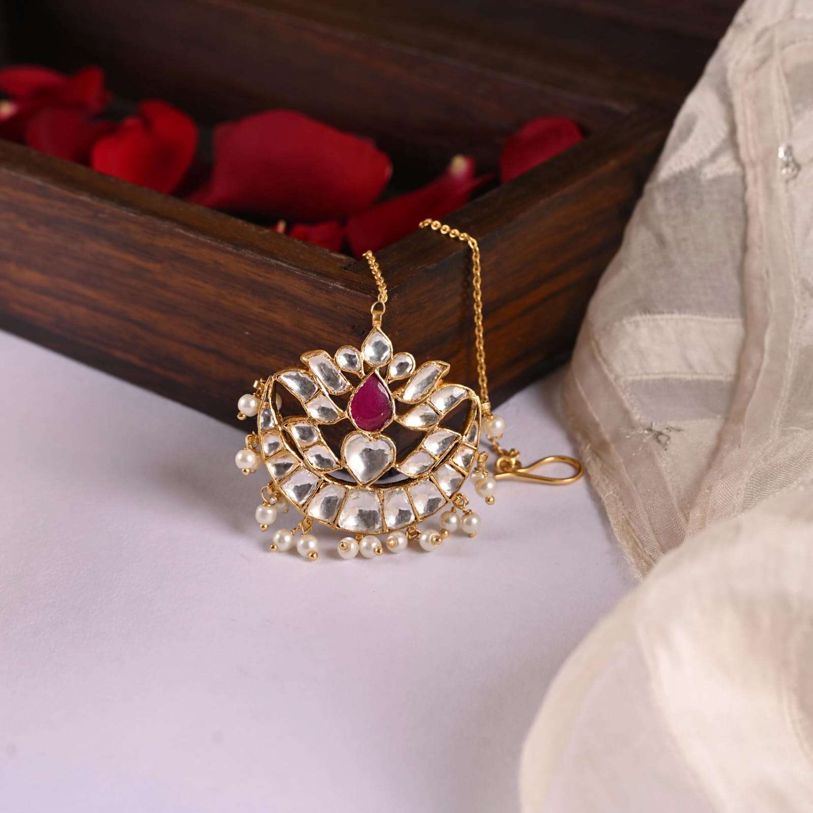 Maangtika in Silver Alloy, handcrafted and dipped in 1 micron Gold plating with Jadau-Polki, and Pearls in traditional antique finish.