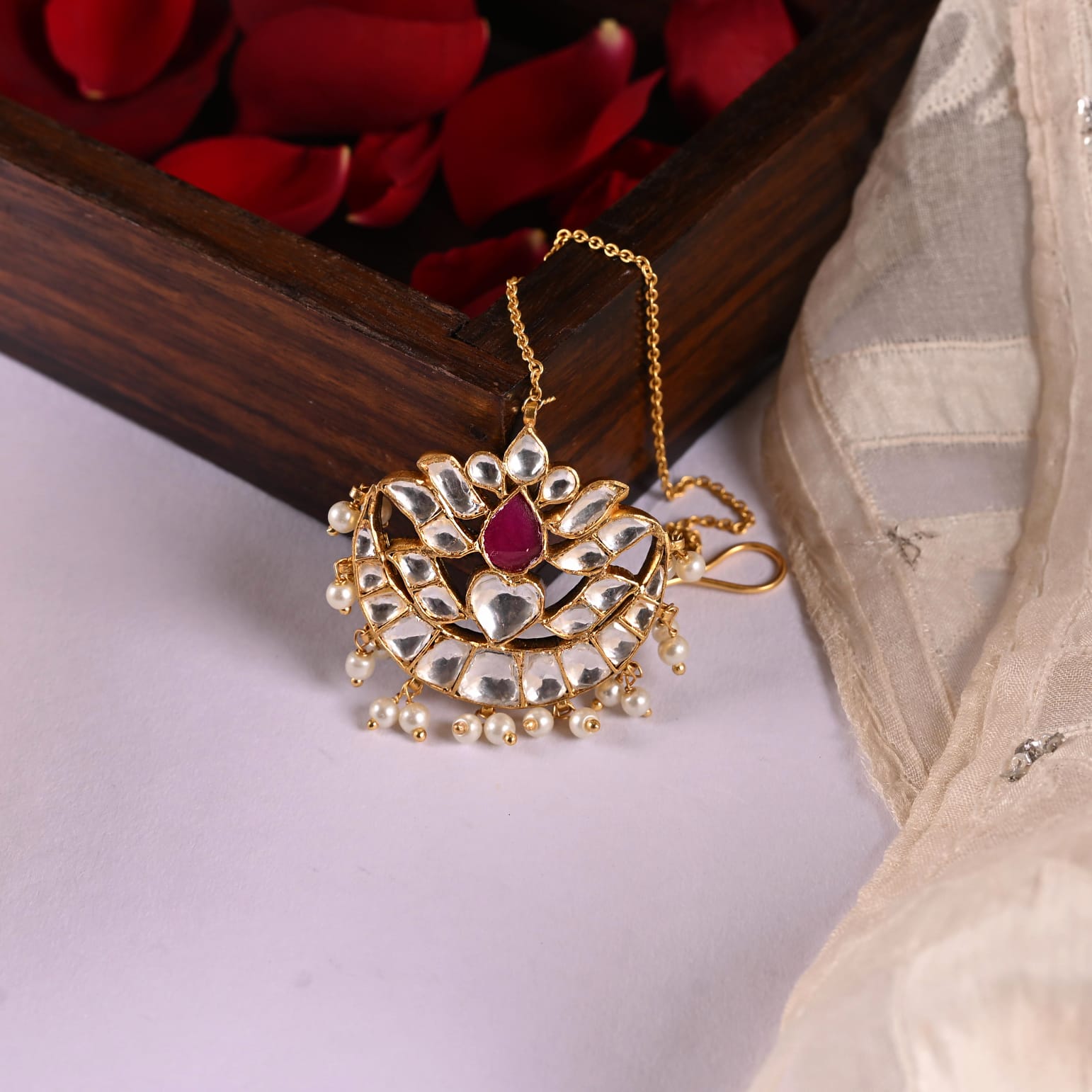 Maangtika in Silver Alloy, handcrafted and dipped in 1 micron Gold plating with Jadau-Polki, and Pearls in traditional antique finish.