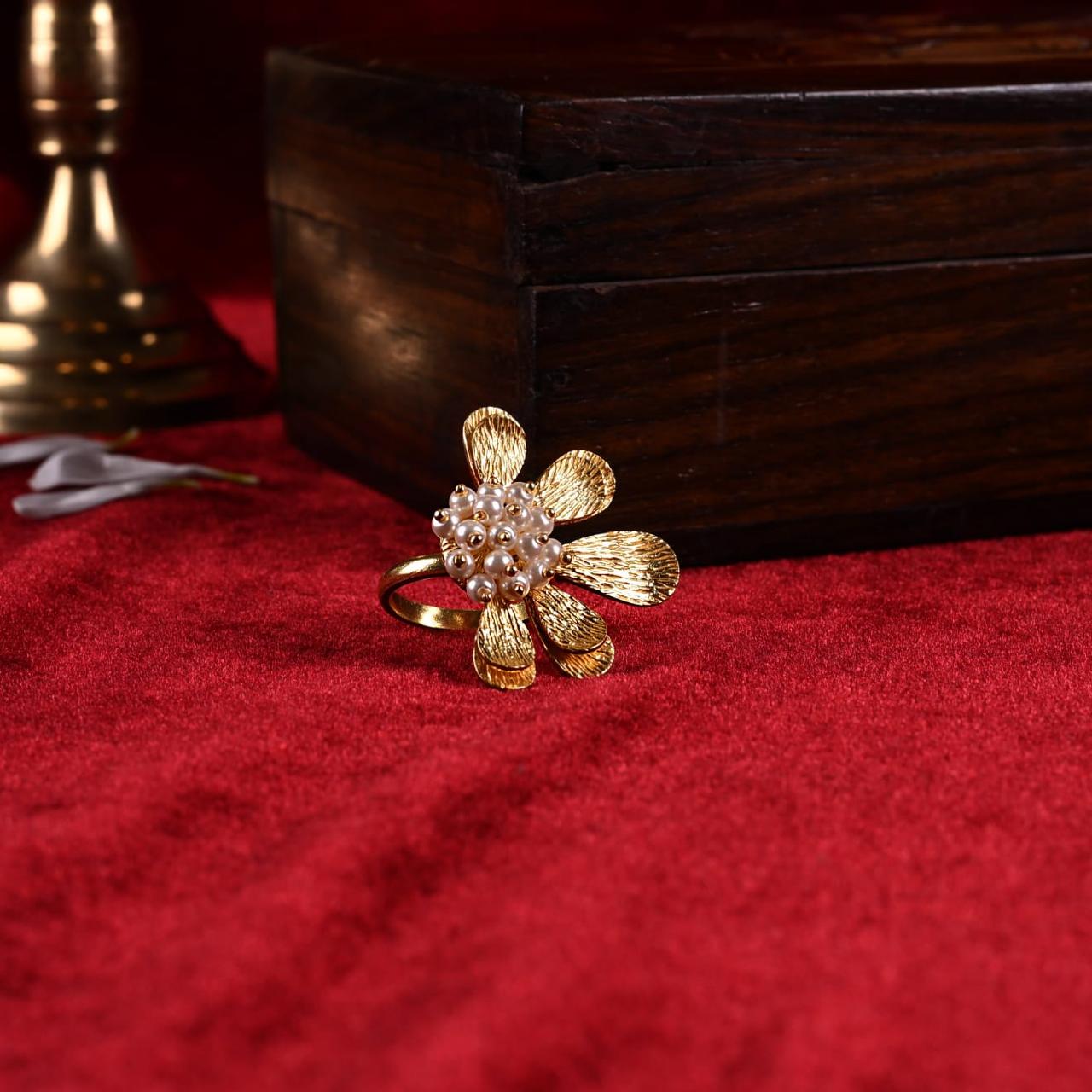 Sterling silver flower ring with hammering and fresh water Pearls.
1 micron gold plating.