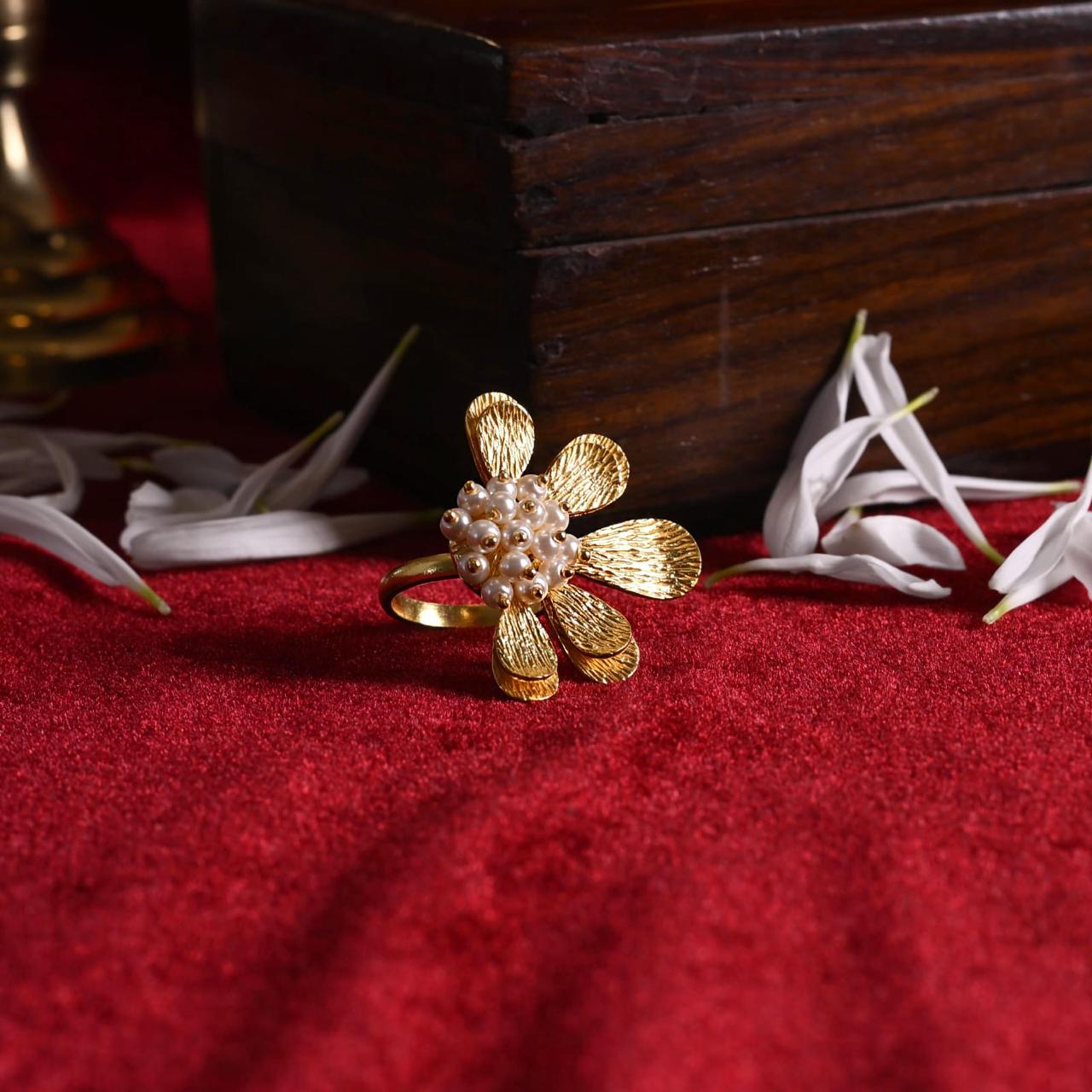 Sterling silver flower ring with hammering and fresh water Pearls.
1 micron gold plating.