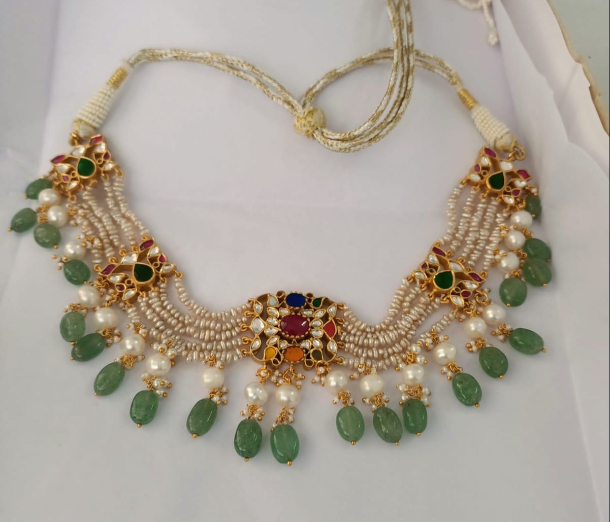 Navrattan choker,

Sterling silver choker with navratan stones and grapes aventurine drops, 1 micron gold plated. 
