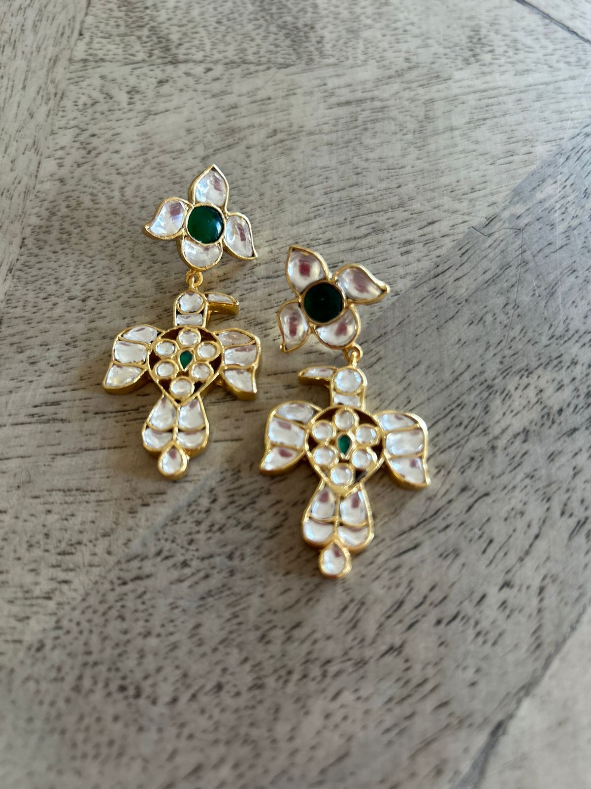 Baaz earrings in Jadau in Sterling Silver with billor Polki and green Onyx stones in 1 micron gold plating with Push-Post closure.