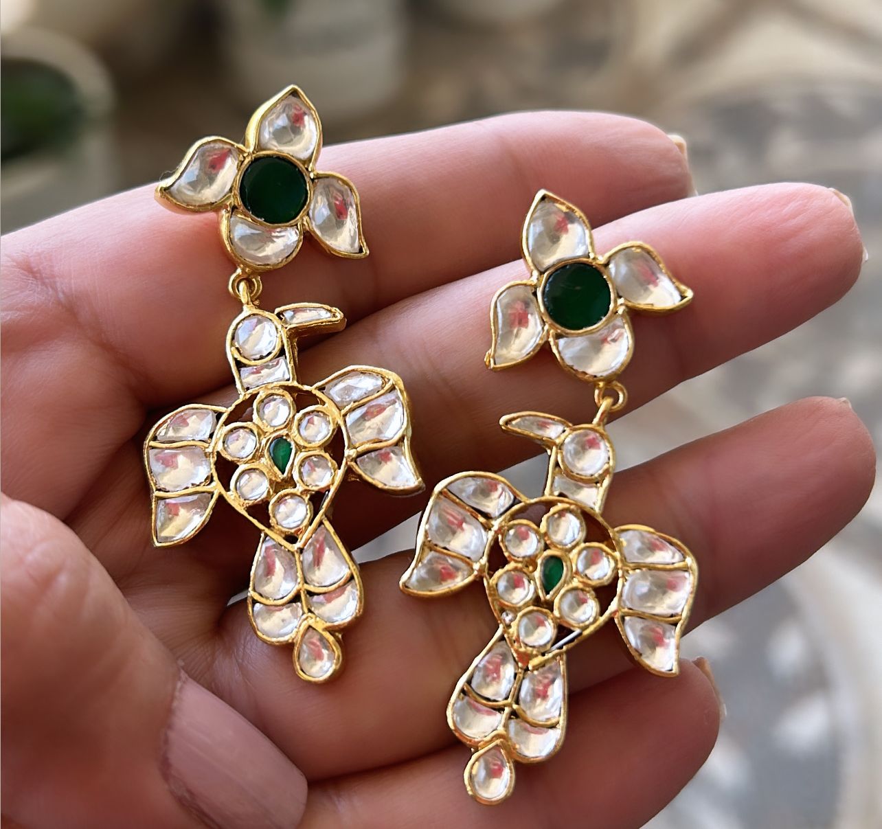 Baaz earrings in Jadau in Sterling Silver with billor Polki and green Onyx stones in 1 micron gold plating with Push-Post closure.