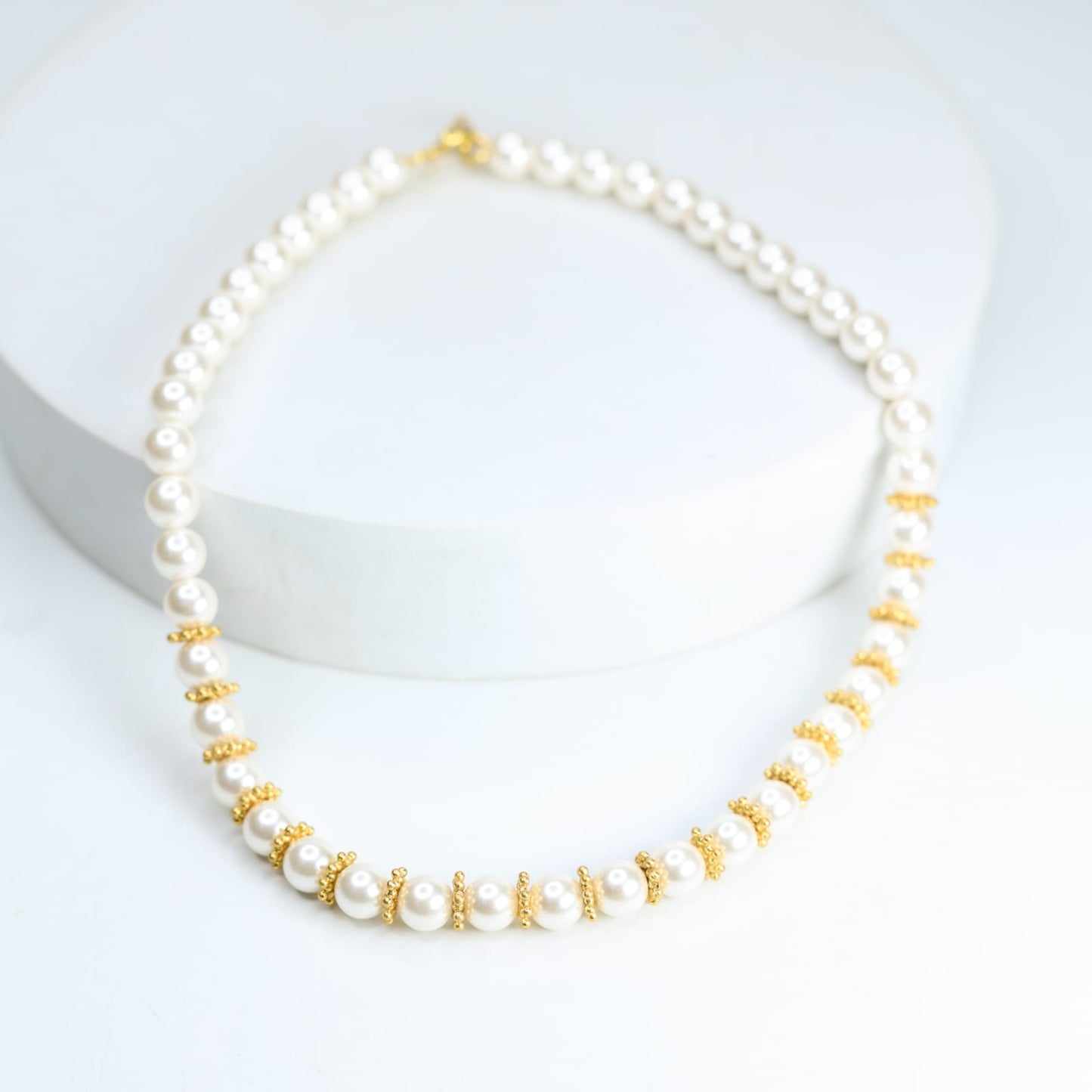 Swarovski pearl necklace with sterling Silver, Gold plated rounds.

Length 17 inches.