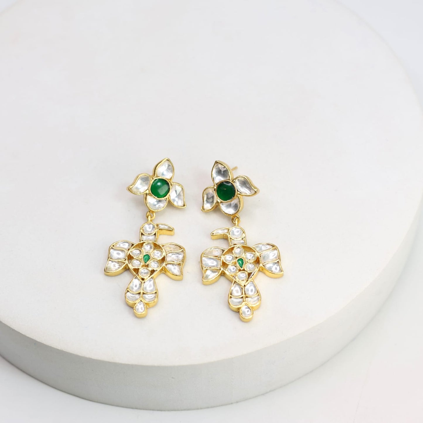 Baaz earrings in Jadau in Sterling Silver with billor Polki and green Onyx stones in 1 micron gold plating with Push-Post closure.