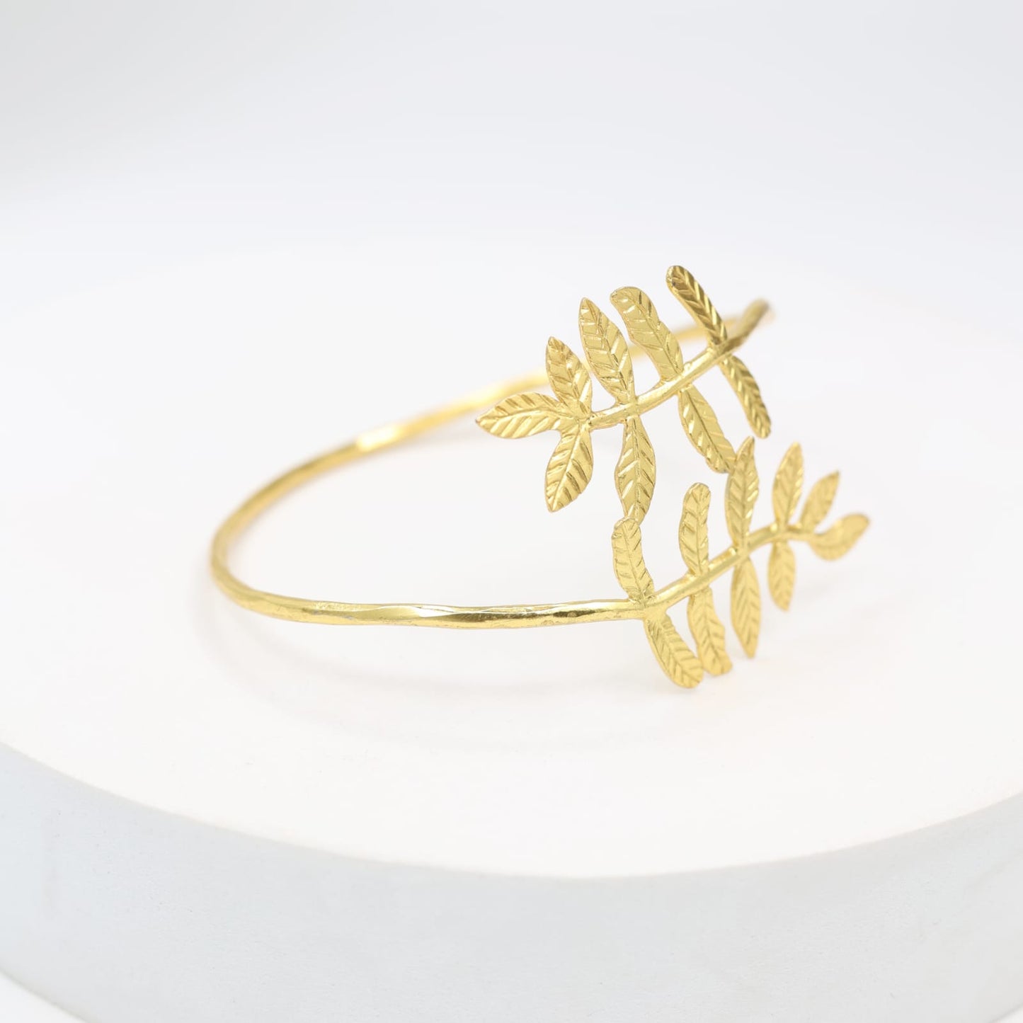 Silver alloy bracelet with 1 micron gold plating in textured design, adjustable.