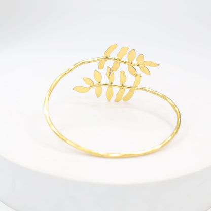 Silver alloy bracelet with 1 micron gold plating in textured design, adjustable.