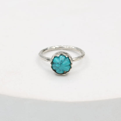 Carved turquoise ring set in sterling Silver, hammered ring band.