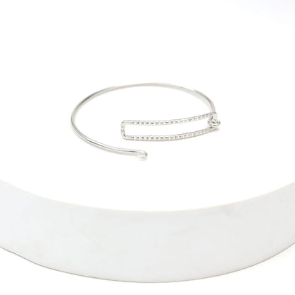 Sterling Silver stacking bracelet in a geometric shape with twisted wire, made to size.