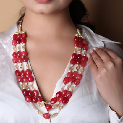 Red tumbles, yellow aventurine and Pearl three layered string necklace in a red thread sarafa closure.