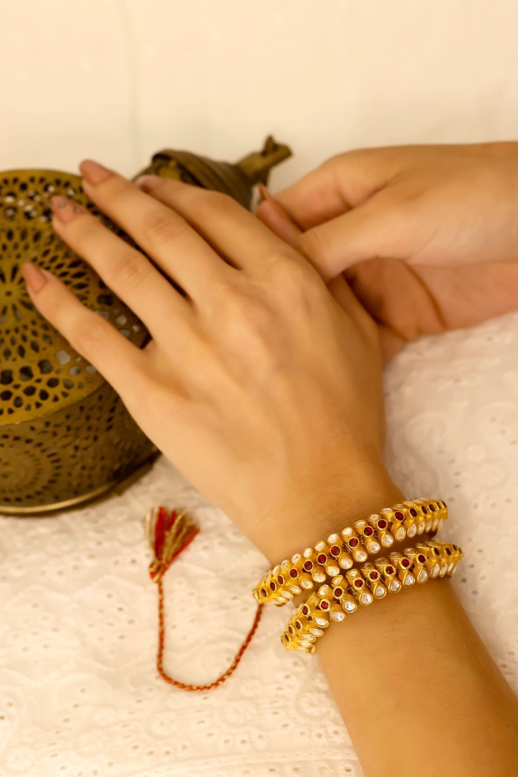 Nandini Bracelet/ponchi in 92.5 Sterling Silver with 1 micron Gold plated Polki in red Quartz jadau in traditional closure/ thread adjustable ponchi.