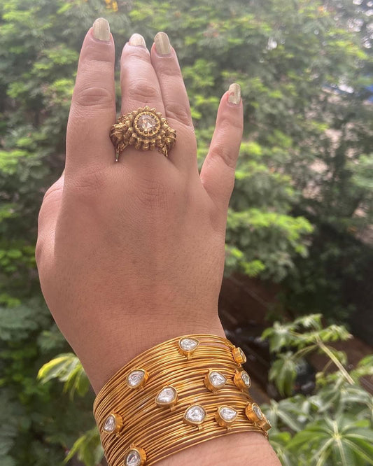 Tarina cuff/bracelet in 92.5 Sterling Silver handcrafted and dipped in 1 micron Gold plating with 22kt Polki with wire texture finish in indo-western look, handsome cuff.