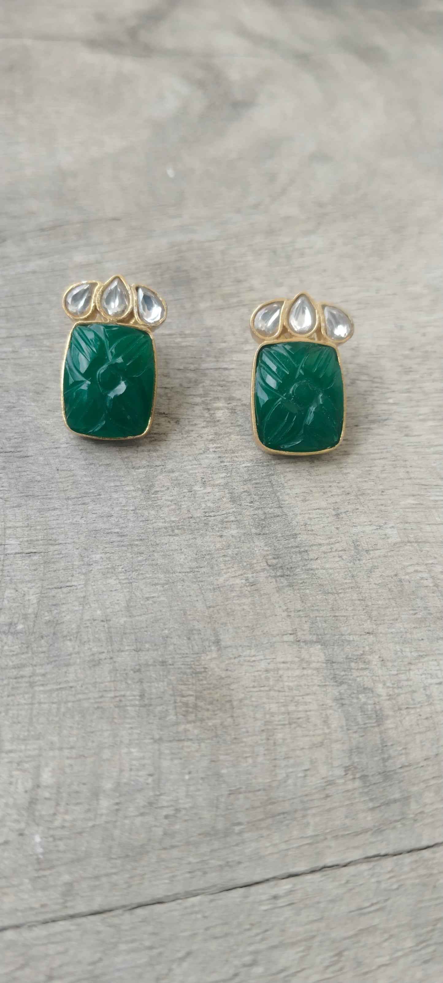 Tabassum earrings/studs in 92.5 Sterling Silver handcrafted and dipped in 1 micron Gold plating in traditional green Onyx caved studs.