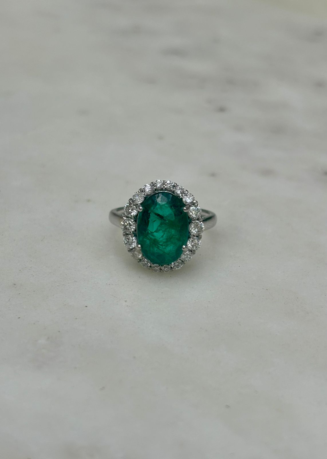 Emerald-Diamond Halo ring in 3.78g Gold.