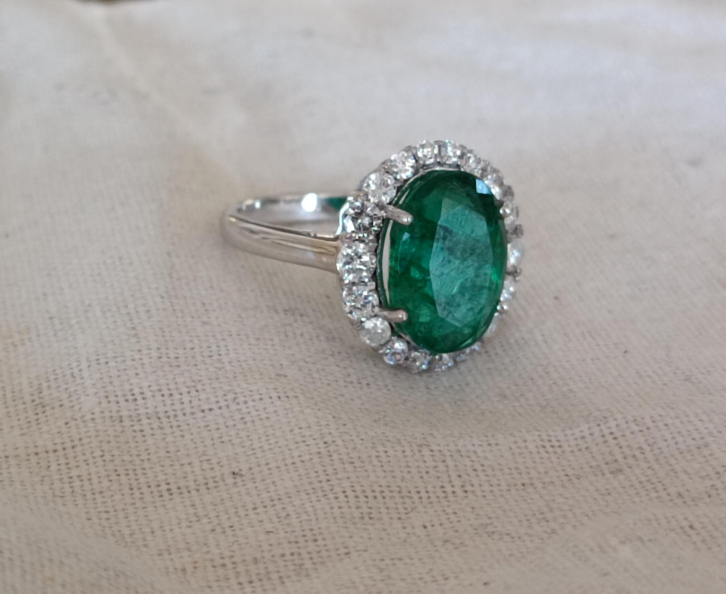 Emerald-Diamond Halo ring in 3.78g Gold.