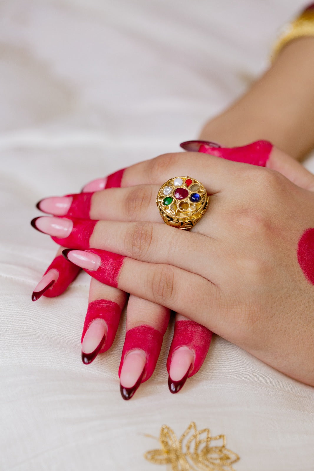 Sterling Silver ring in Navrattan stones with 18 Karat Gold plating.