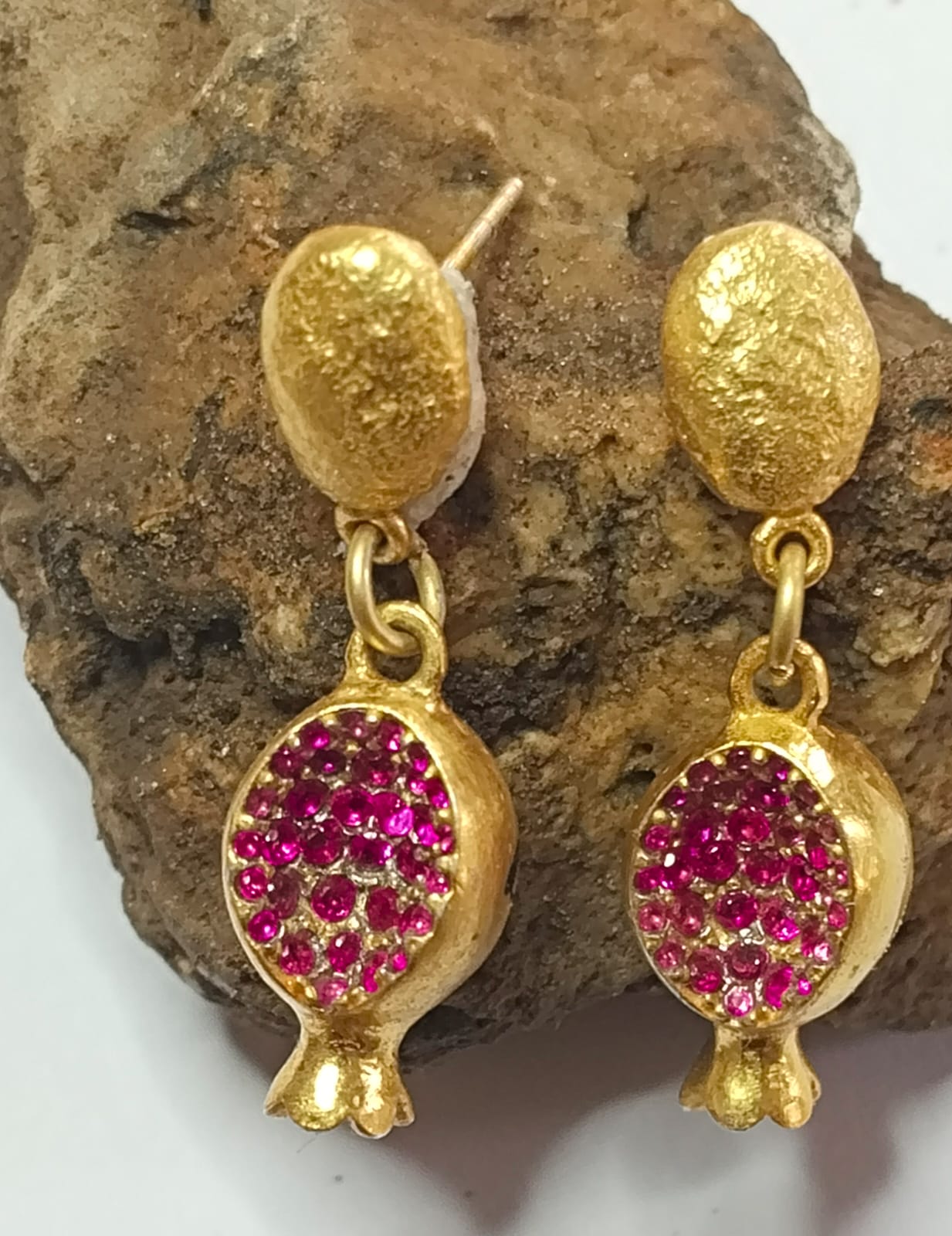 Anaar earrings in 92.5 Sterling Silver handcrafted and dipped in 1 micron Gold Plating, set with red stones in Push-Post closure.