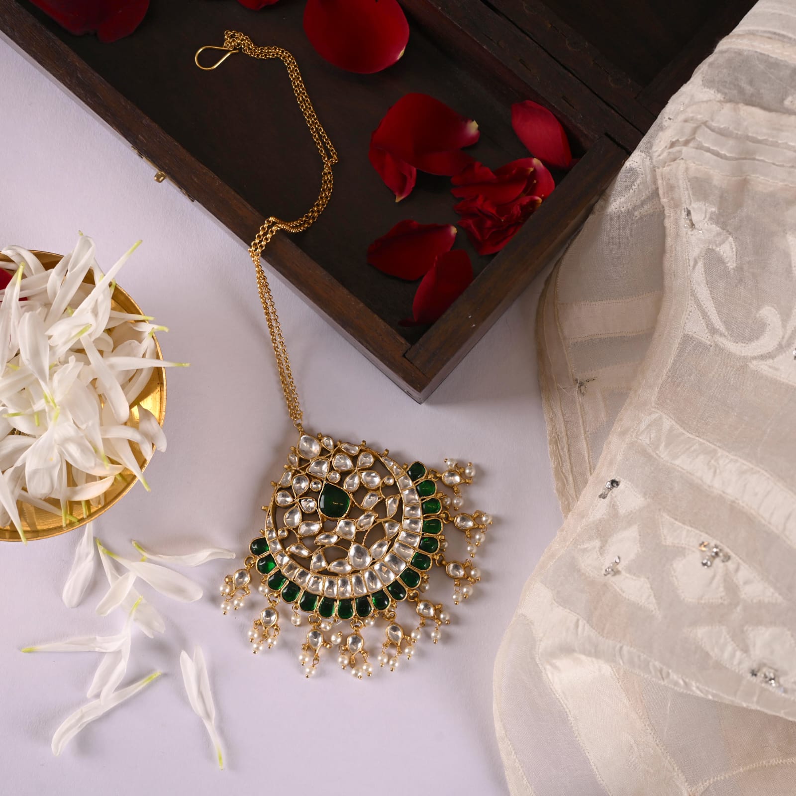 Oversized Maangtika in Silver Alloy handcrafted and dipped in 1 micron Gold plating in traditional Jadau-Polki in antique finish.